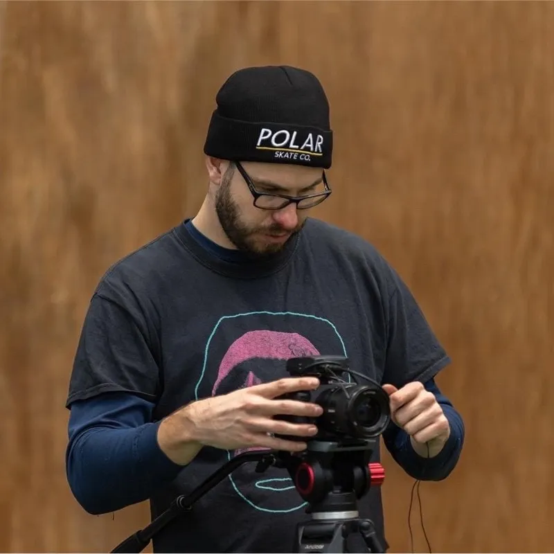 Sam Dixon setting up a camera on a tripod